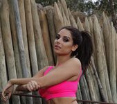Charley outdoors in her pink and black sporty ensemble