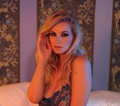 Jess Davies teasing on the bed in her blue see through