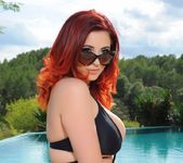Lucy V teases by the pool in her black bikini 4