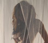 Lily poses behind a sheer curtain and teases 7