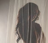 Lily poses behind a sheer curtain and teases 15