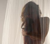 Lily poses behind a sheer curtain and teases 17