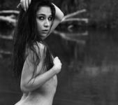 Ally poses nude by the river 5