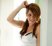 Hailey Leigh poses in a cute little skirt next to the window 5